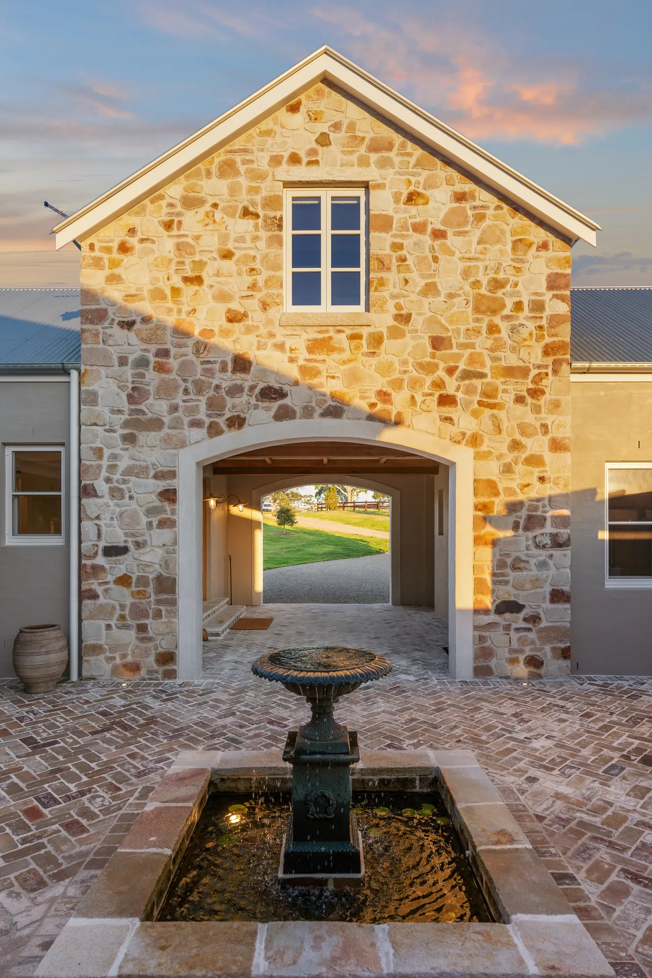 Stone arch and fountain in the barn courtyard