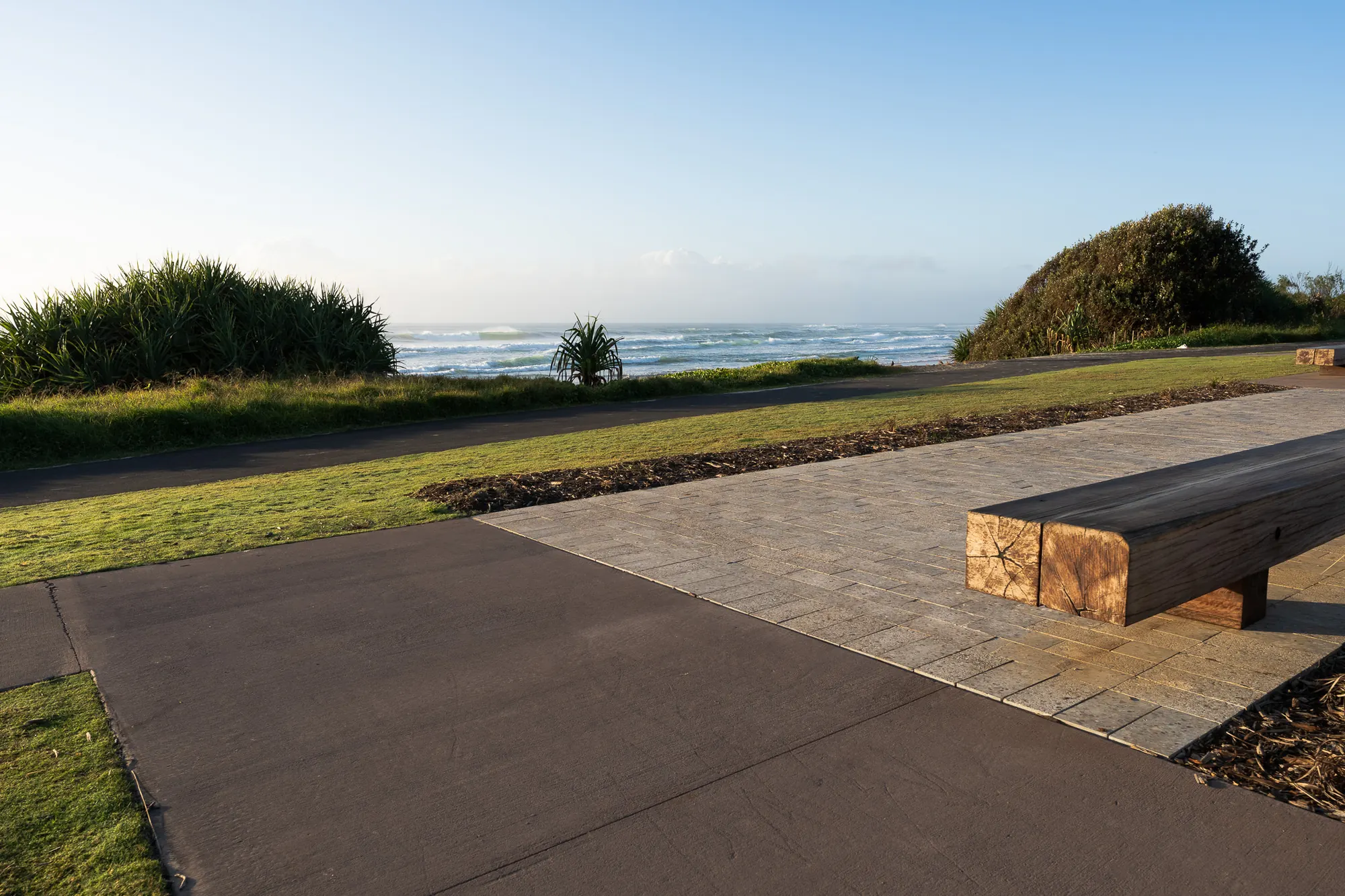 A concrete and paver shared path running along the dune at Sharpes Beach