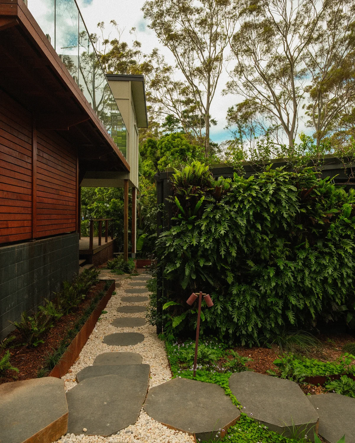 A kept garden path with clipped hedging either side